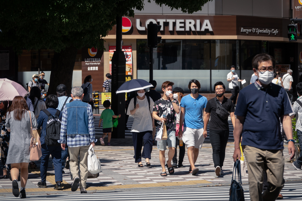 people walking with masks in tokyo