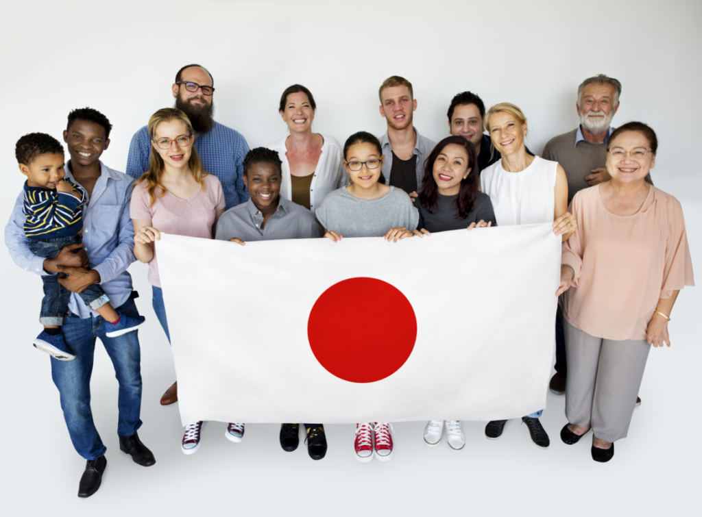 Smiling international group holding Japanese flag