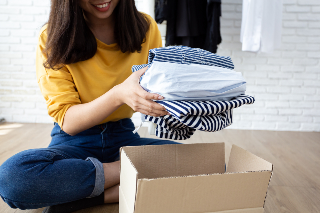 Woman sorting clothes into box
