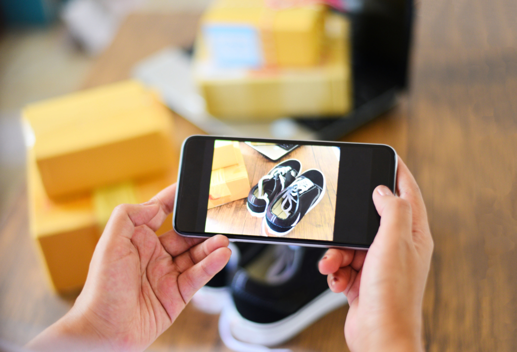 Person taking picture of sneakers with smartphone