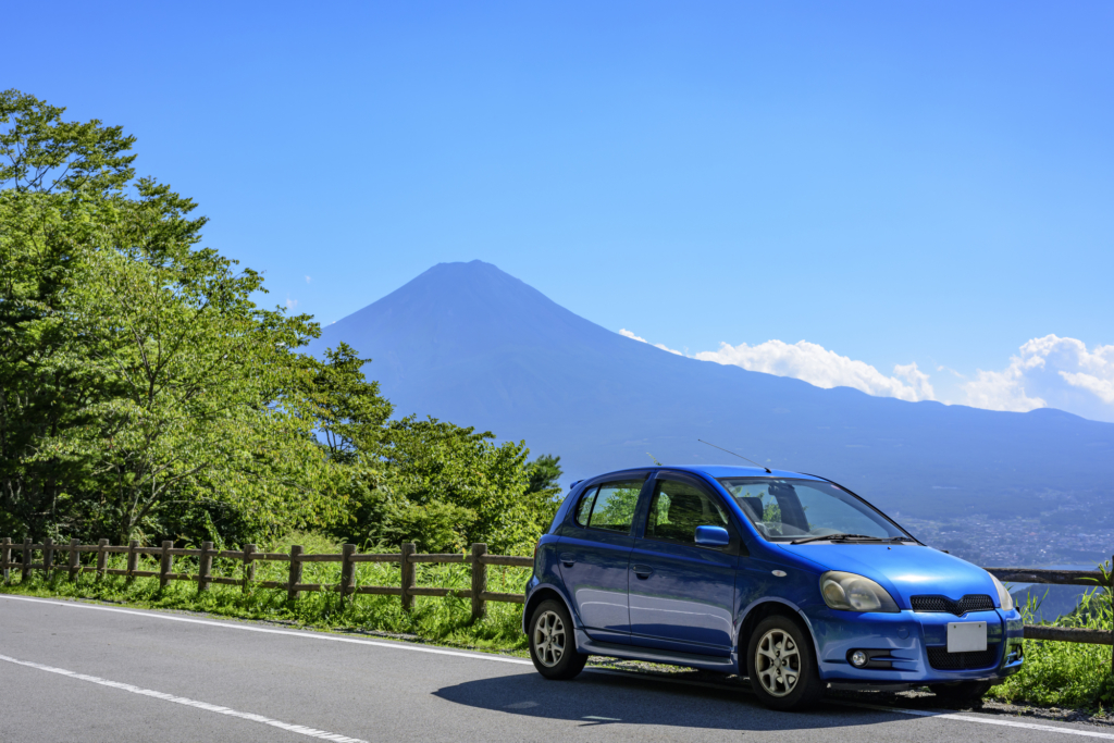 Car on the road with Mt Fuji in background