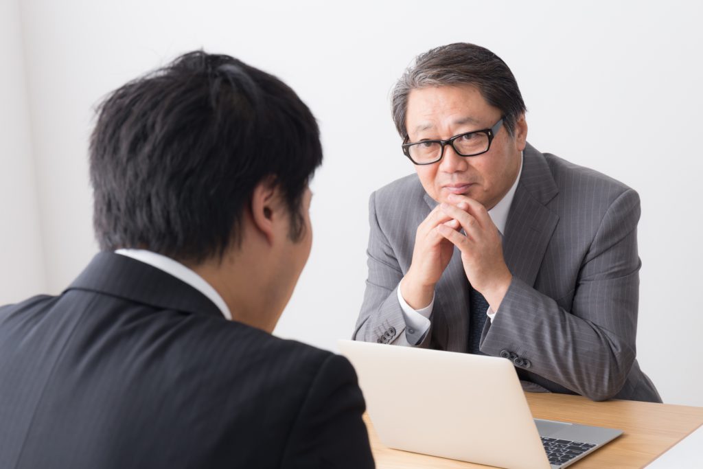 Japanese worker talking with boss